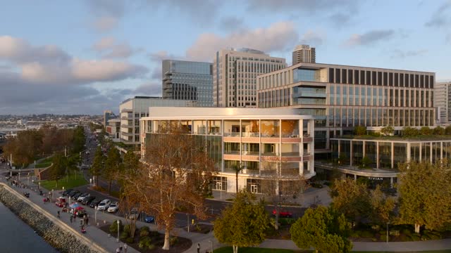 Low aerial view of the downtown streets, homes and the buildings at Embarcadero, with people walking.