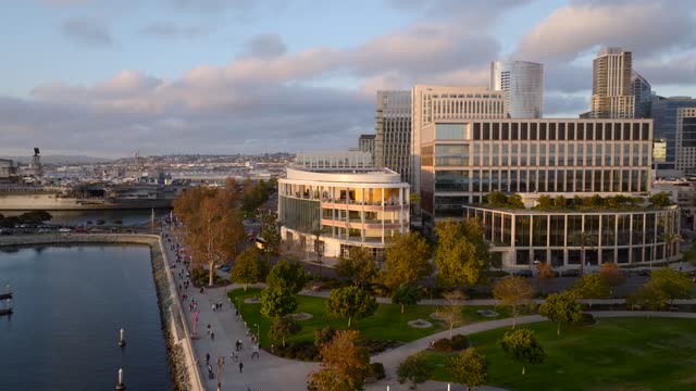 Low aerial view of the downtown streets, the skyline and boats at Embarcadero, with people walking.