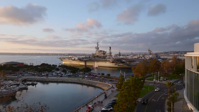 Aerial footage of the USS Midway and Tuna Harbor Downtown San Diego Waterfront during Sunset | Drone Video – 1