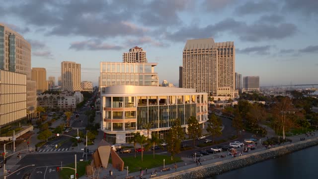 Low aerial view of the downtown streets, the skyline and boats at Embarcadero, with people walking.