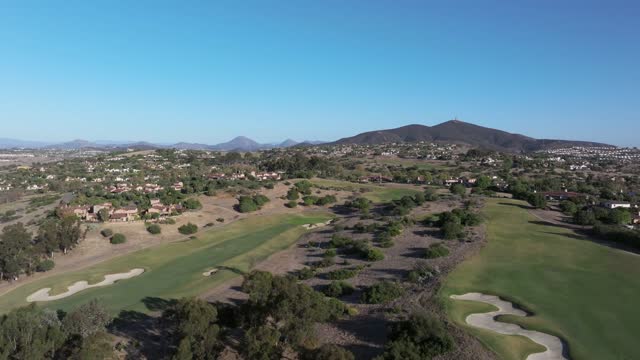 Low aerial view of the country inland, homes and open country in Santaluz.