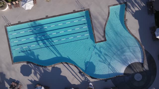 Aerial footage of the Pool at the Private Country Club Golf Club and Golf Course Santaluz on a sunny day | Drone Video – 1