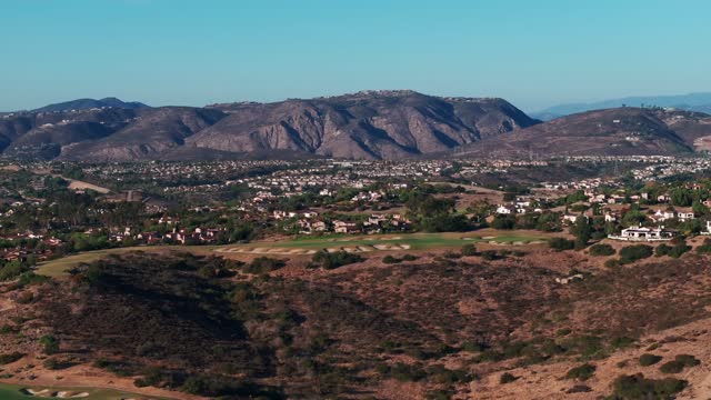 Aerial view of the country inland, homes and open country in Santaluz.