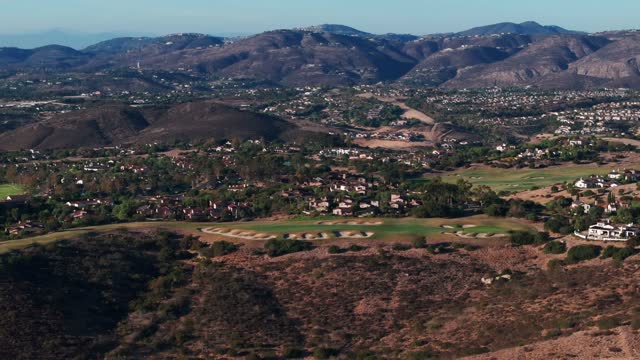 Aerial view of the country inland, homes and open country in Santaluz.