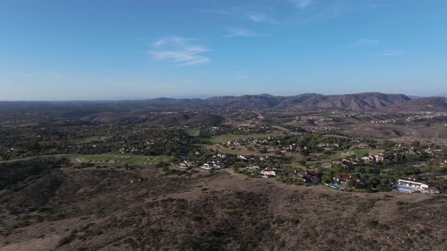 Aerial view of the country inland, homes and open country in Santaluz.