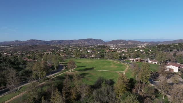 Aerial view of the country inland, homes and the buildings in Santaluz, with people walking.
