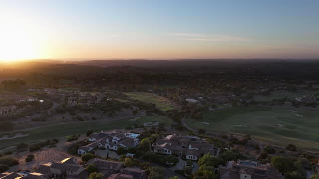 Aerial view of a residential street, homes and open country in Santaluz.