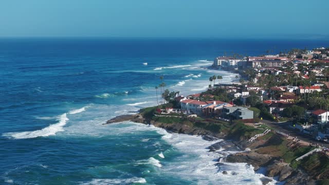 Aerial view of the cliffs, the surf and palm trees at Beach Barber Tract.