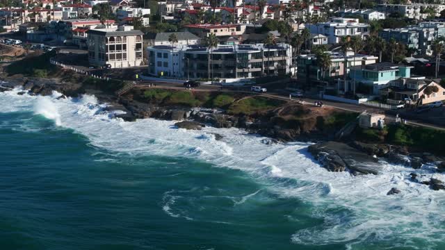 Aerial view of a residential street, the surf and palm trees at Beach Barber Tract.