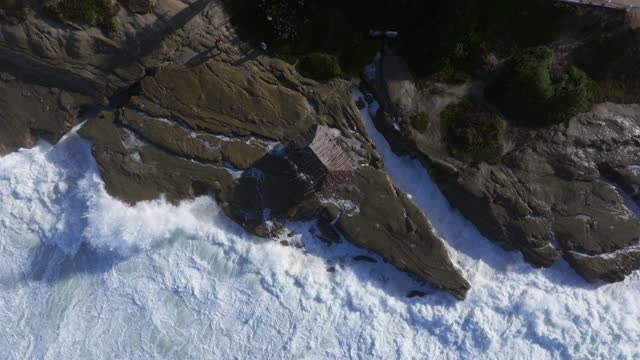 Aerial view of the cliffs, the surf and the ocean at Beach Barber Tract.
