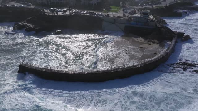 Aerial view of the beach, the surf and the ocean at La Jolla Village.