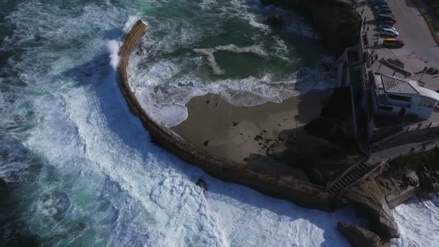 Aerial view of the beach, the surf and the ocean at La Jolla Village.