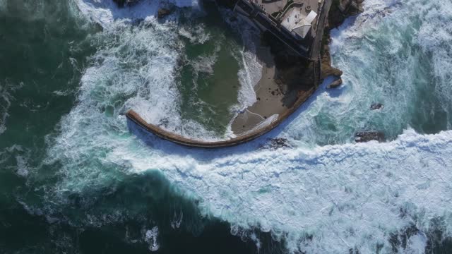 Aerial view of the beach, the surf and the ocean at La Jolla Village.
