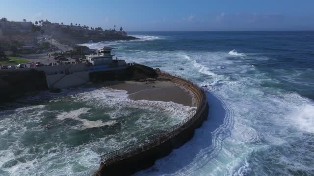 Aerial view of the beach, the surf and the ocean at La Jolla Village.