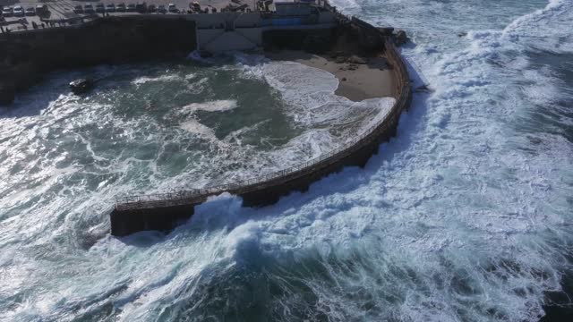 Aerial view of the beach, the surf and the ocean at La Jolla Village.