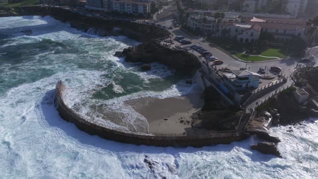 Aerial view of the beach, the surf and the ocean at La Jolla Village.