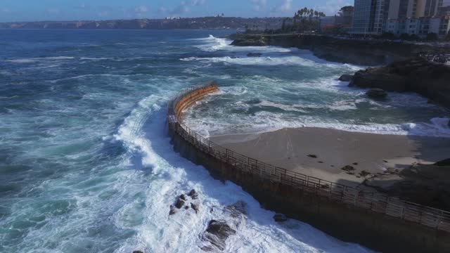 Aerial view of the beach, the surf and the ocean at La Jolla Village.