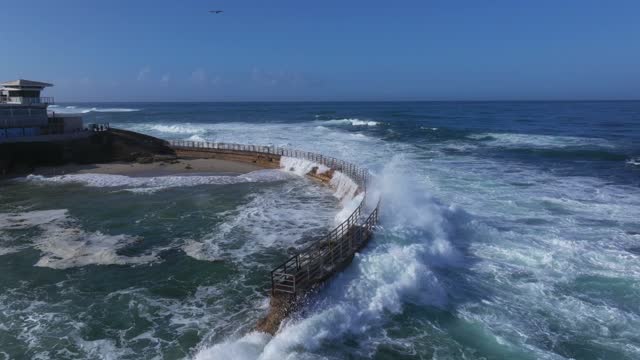 Aerial view of the beach, the surf and the ocean at La Jolla Village.