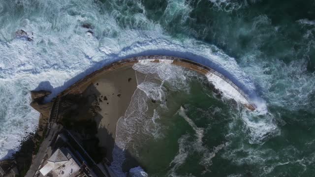Aerial view of the beach, the surf and the ocean at La Jolla Village.