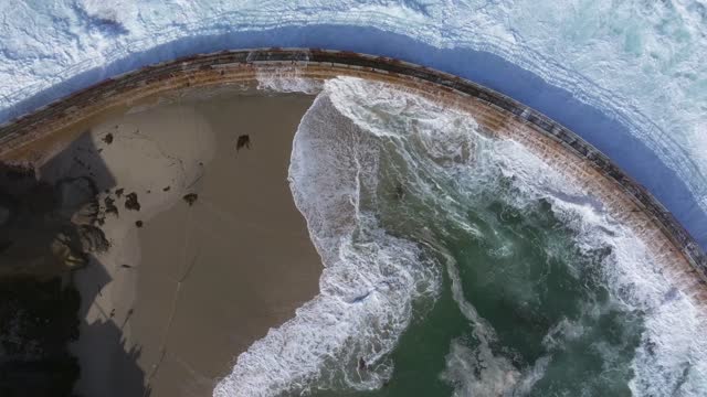 Aerial view of the beach, the surf and the ocean at La Jolla Village.
