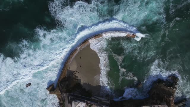 Aerial view of the beach, the surf and the ocean at La Jolla Village.