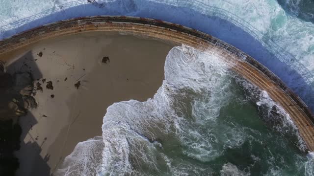 Aerial view of the beach, the surf and the ocean at La Jolla Village.