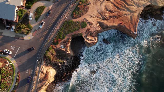 Aerial view of the cliffs, the surf and the ocean at Sunset Cliffs.
