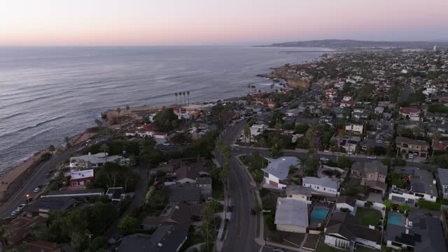 Aerial view of a residential street, palm trees and the ocean at Sunset Cliffs.