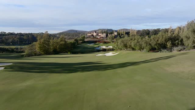 Low aerial view of the country inland, the buildings and open country at The Bridges.