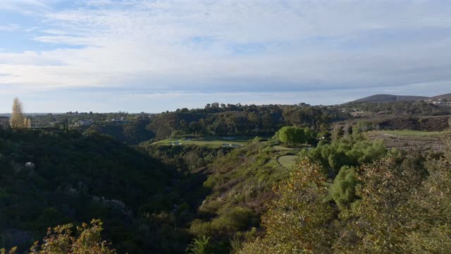 Low aerial view of the country inland, homes and open country at The Bridges.