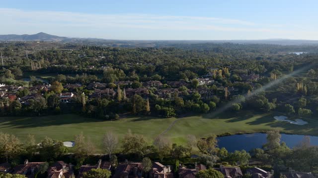 Aerial view of a residential street, homes and open country at The Bridges.