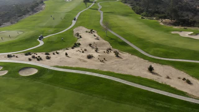 Aerial view of a park, traffic and open country at Torrey Pines, with people walking.