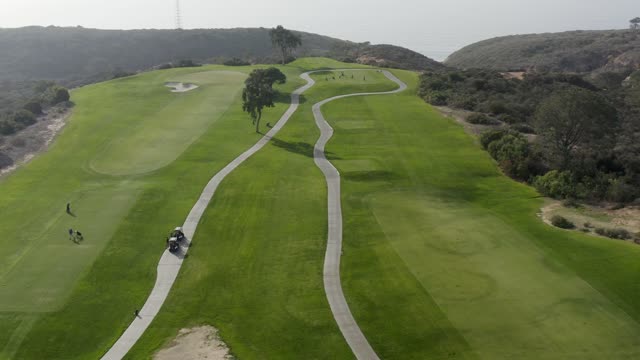 Aerial view of the country inland, traffic and open country at Torrey Pines, with people walking.