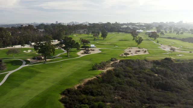 Aerial view of a park, the skyline and the city at Torrey Pines, with people walking.