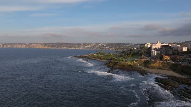 Aerial view of the cliffs, the surf and the ocean at La Jolla Cove.