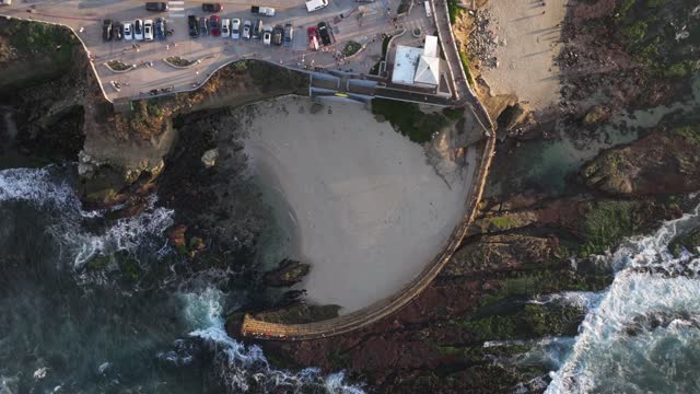 Aerial view of the beach, the ocean and the cliffs at La Jolla Cove.