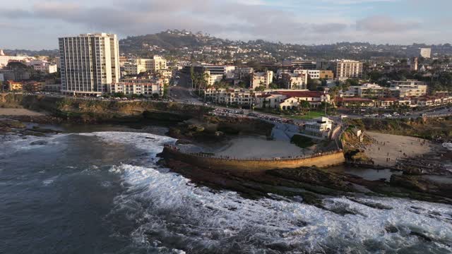 Aerial view of the cliffs, the surf and the ocean at La Jolla Cove.