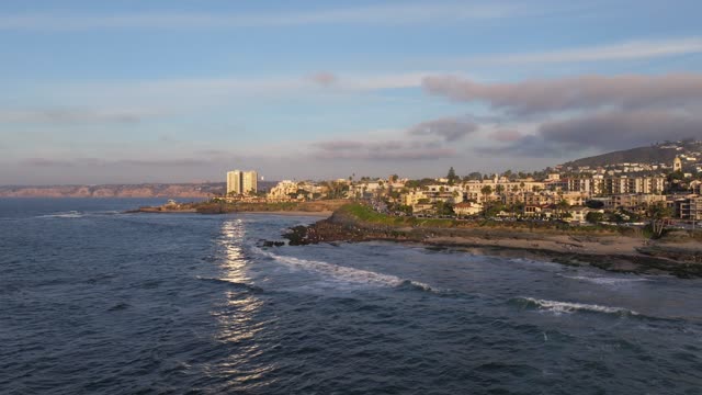 Aerial view of the cliffs, the surf and the ocean at La Jolla Cove.