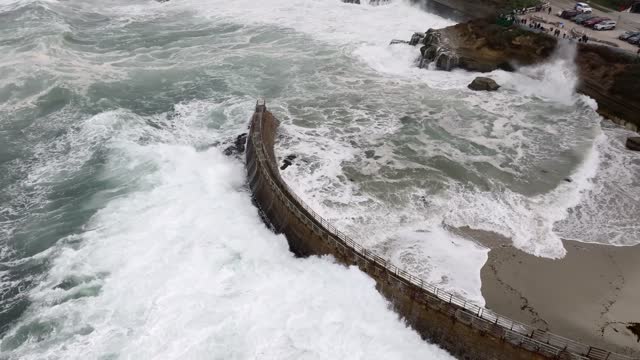 Aerial view of the cliffs, the surf and the ocean at La Jolla Cove.