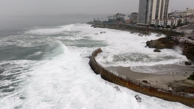 Aerial view of the cliffs, the surf and the ocean at La Jolla Cove.