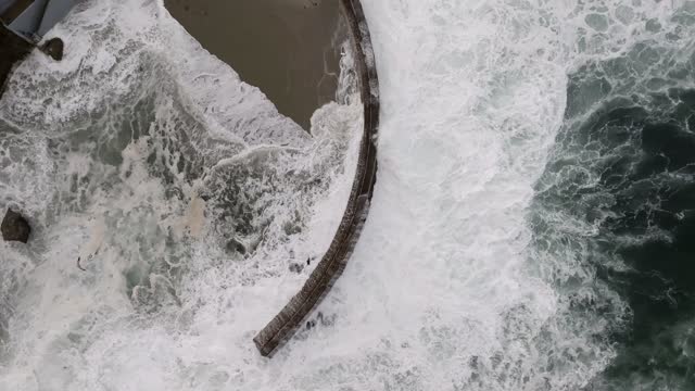 Aerial view of the beach, the surf and the ocean at La Jolla Cove.