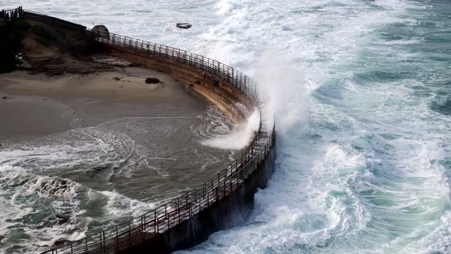 Aerial view of the cliffs, the surf and the ocean at La Jolla Cove.