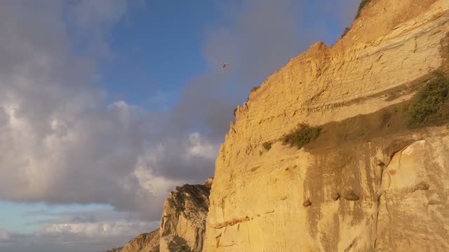 Low aerial view of the cliffs and open country at Black’s Beach.