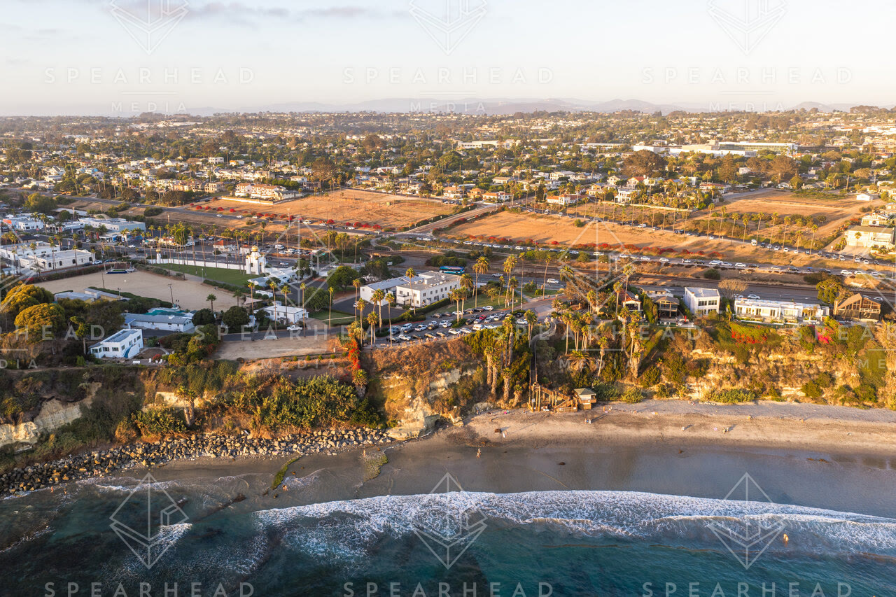 Aerial view of the cliffs, the surf and palm trees at Swamis.