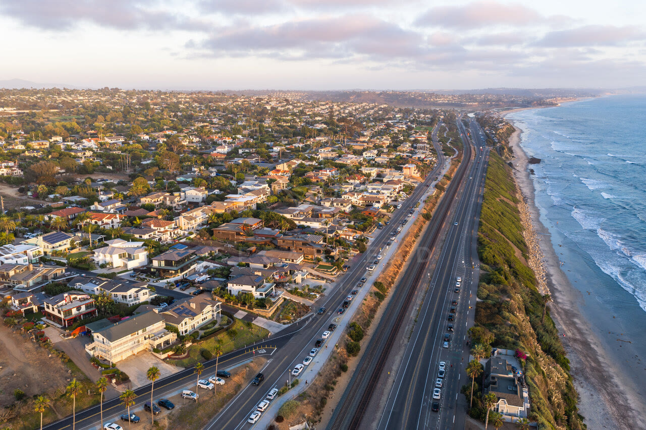 Aerial view of a residential street, the ocean and homes at Swamis.