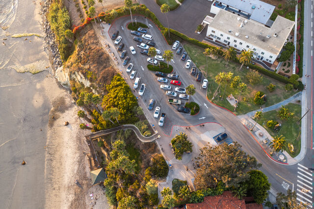 Aerial shot of Swami's Beach parking lot and coastline in Encinitas | Drone Photo
