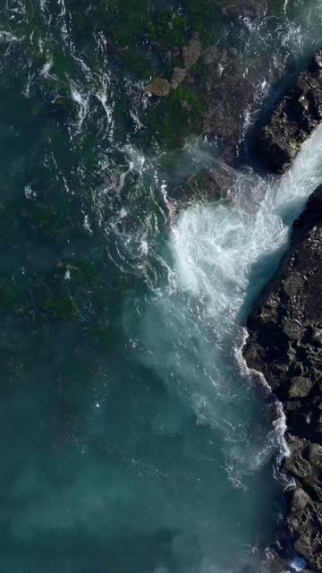 Aerial view of the cliffs, the surf and the ocean at La Jolla Cove.