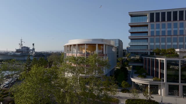 Aerial footage of birds flying over the RADD building and USS Midway Museum along the Embarcadero in downtown San Diego | Drone Video