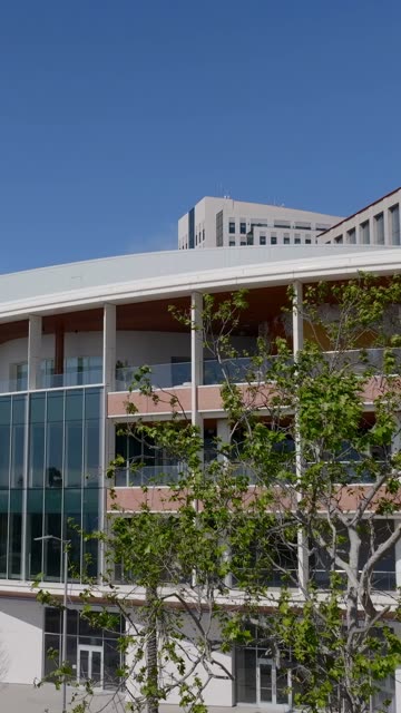 Aerial footage of the Research and Design District RADD building and skyline near the Embarcadero in Downtown San Diego | Vertical Drone Video