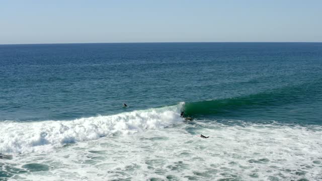 Surfer on a longboard on a beautiful day at Cardiff State Beach Encinitas | Drone Video